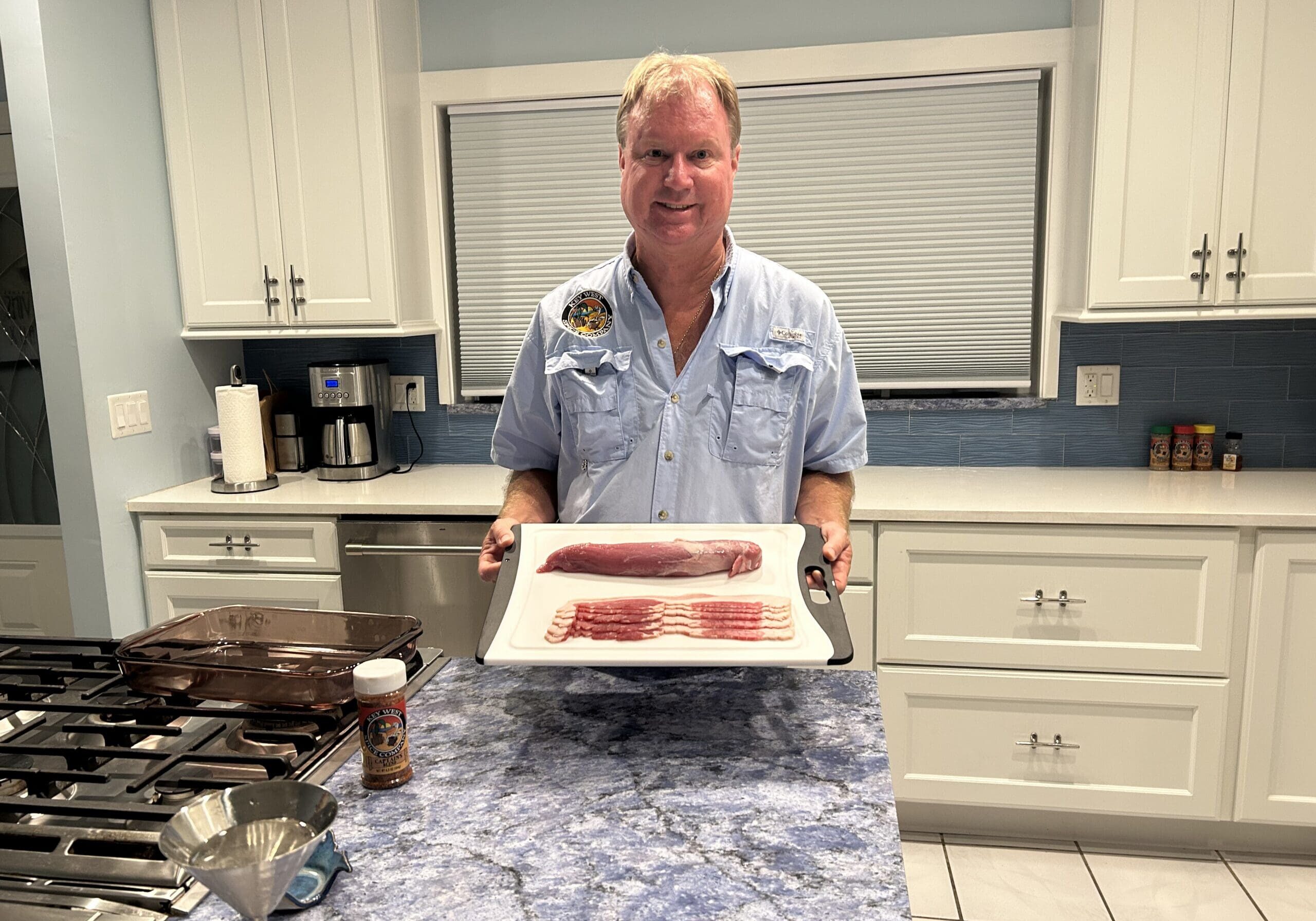 Person holding cutting board with bacon slices